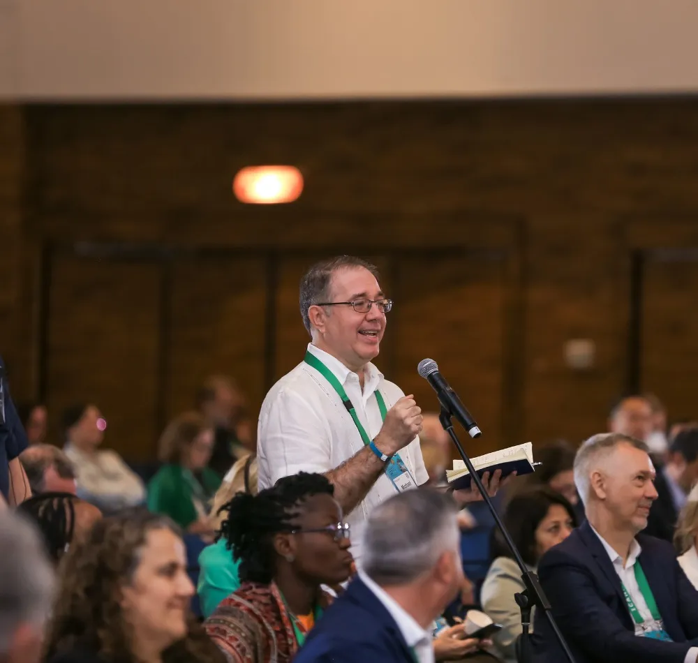 Attendee speaking into a microphone from the audience at a conference session