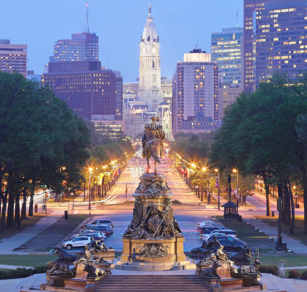 Philadelphia City Hall and skyline seen down the Benjamin Franklin Parkway at dusk