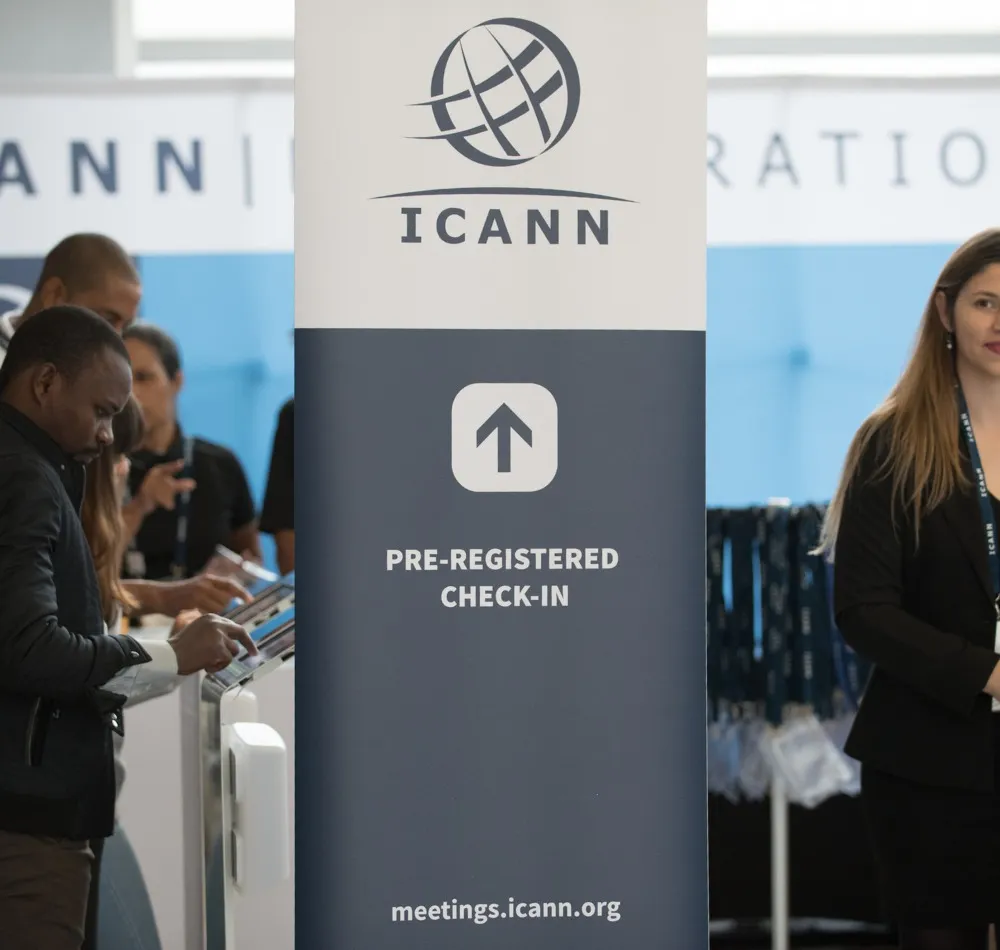 ICANN pre-registered check-in sign beside attendees at registration kiosks