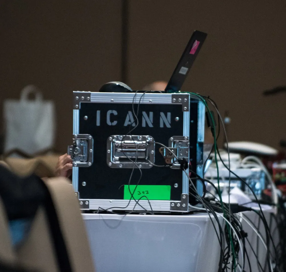 ICANN equipment flight case with cables on a table at a meeting